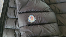 Load image into Gallery viewer, Gray puffer jacket with Moncler logo on a neutral background