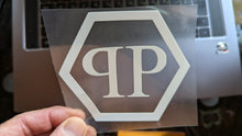 Load image into Gallery viewer, Clear decal with PP Philipp Plain logo held over a laptop